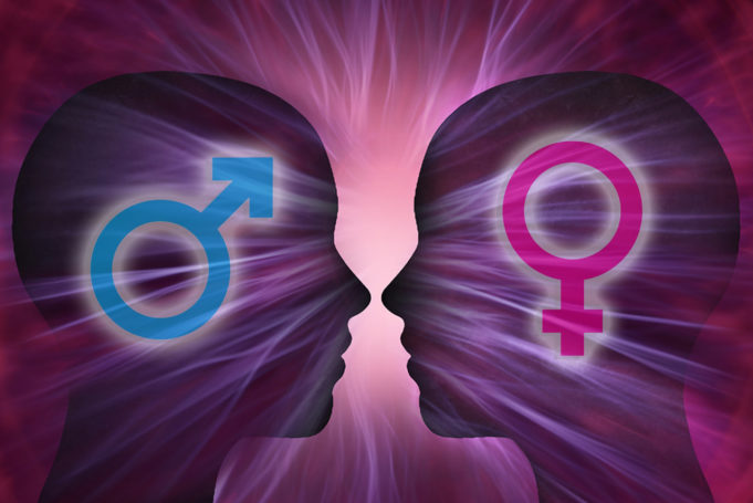 Two Human silhouettes with a male and female symbol, rays of light and energy. - Bruno Cinti discusses how as transgender people, we can make a difference in our communities with our unique perspective on gender and its roles.