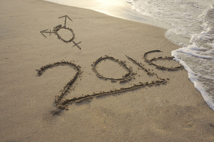 A transgender symbol and 2016 written in the sand on a beach with the water coming in.- Jude Samson briefly recaps some of the ups and downs of 2016 for transgender people, including those we've lost.